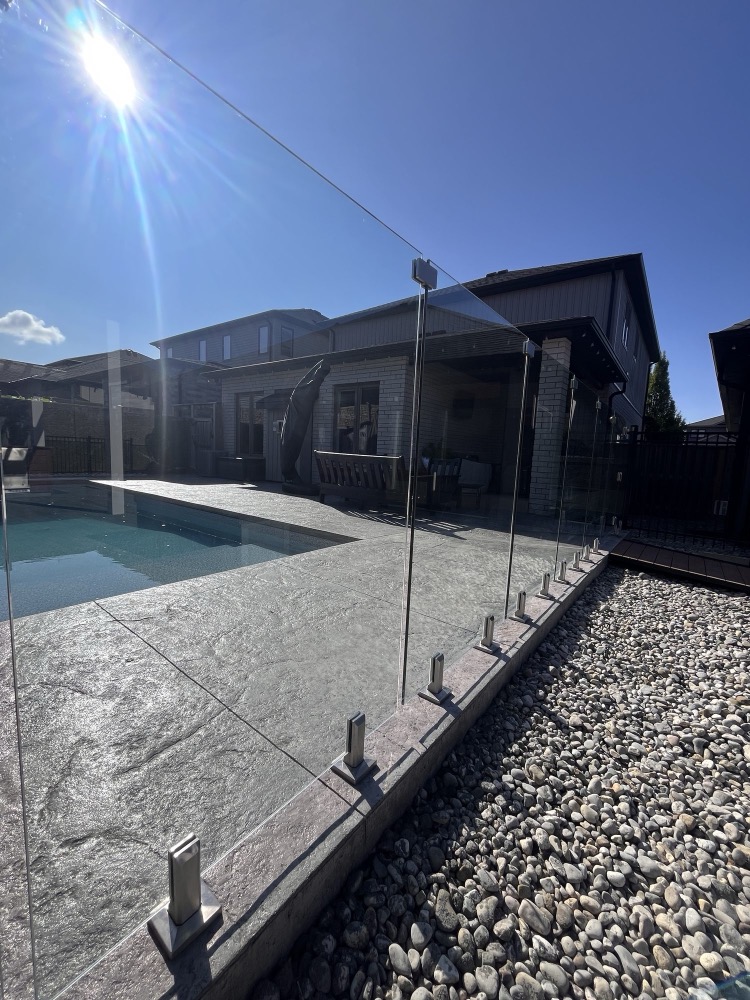 Clean glass pool railing after window washing in London, Ontario